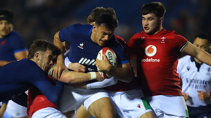 France U20's centre Mathys Belaubre (C) is tackled during the U20 Six Nations international rugby union match between Wales and France at Cardiff Arms Park in south Wales on March 7, 2024. (Photo by Geoff Caddick / AFP)