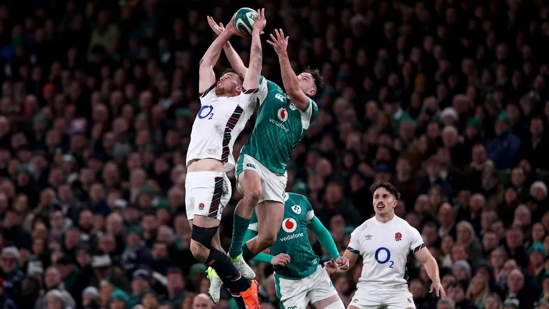 England's Freddie Steward competes in the air with Ireland's Hugo Keenan during the 2025 Guinness Six Nations Championship.