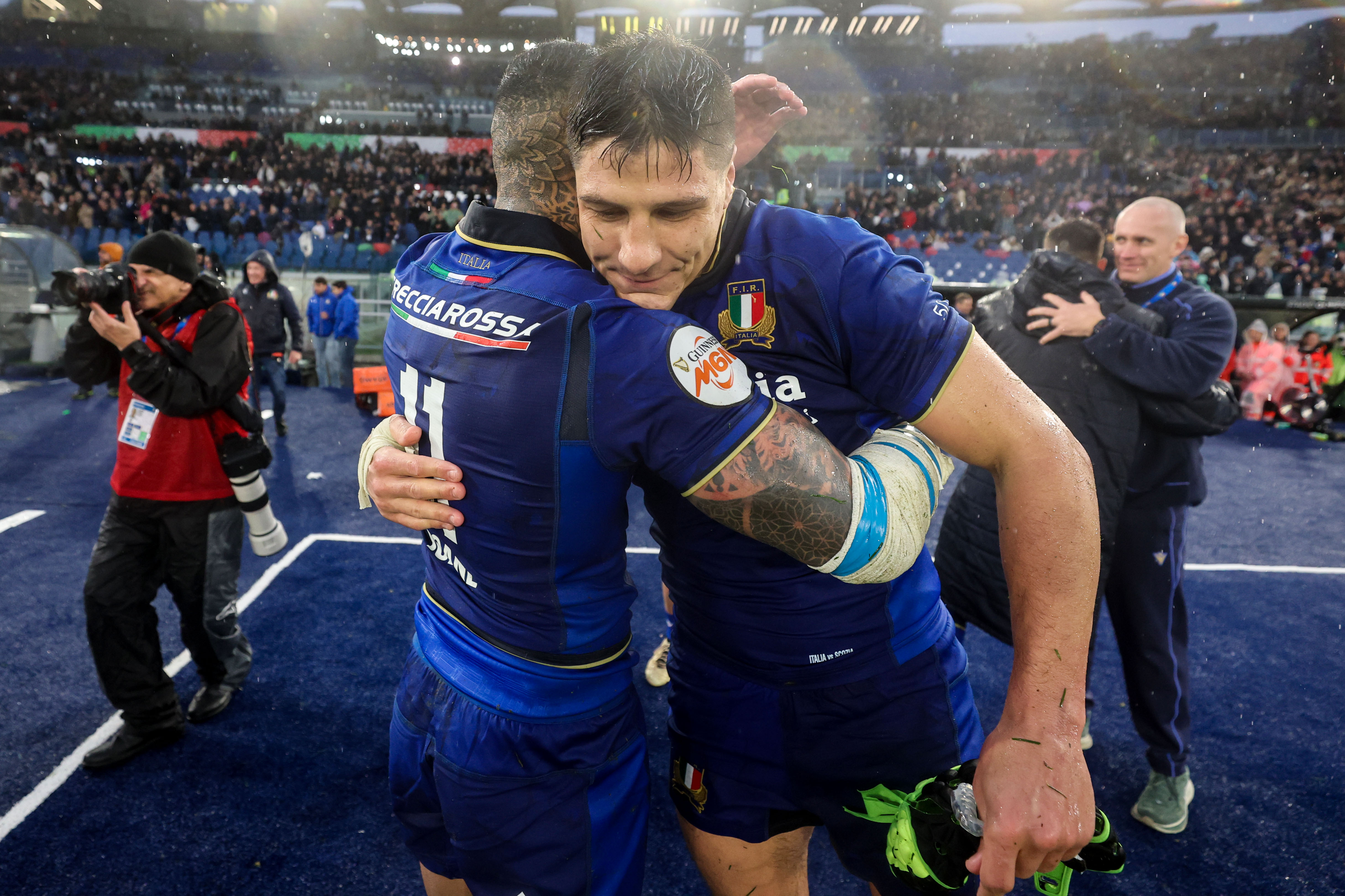 Italy's Monty Ioane and Juan Ignacio Brex embrace after the 2026 Championship win against Scotland.