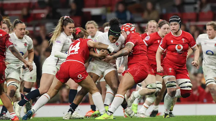 England's Sadia Kabeya is tackled by Wales' Lisa Neumann and Donna Rose during the 2025 Guinness Women's Six Nations.