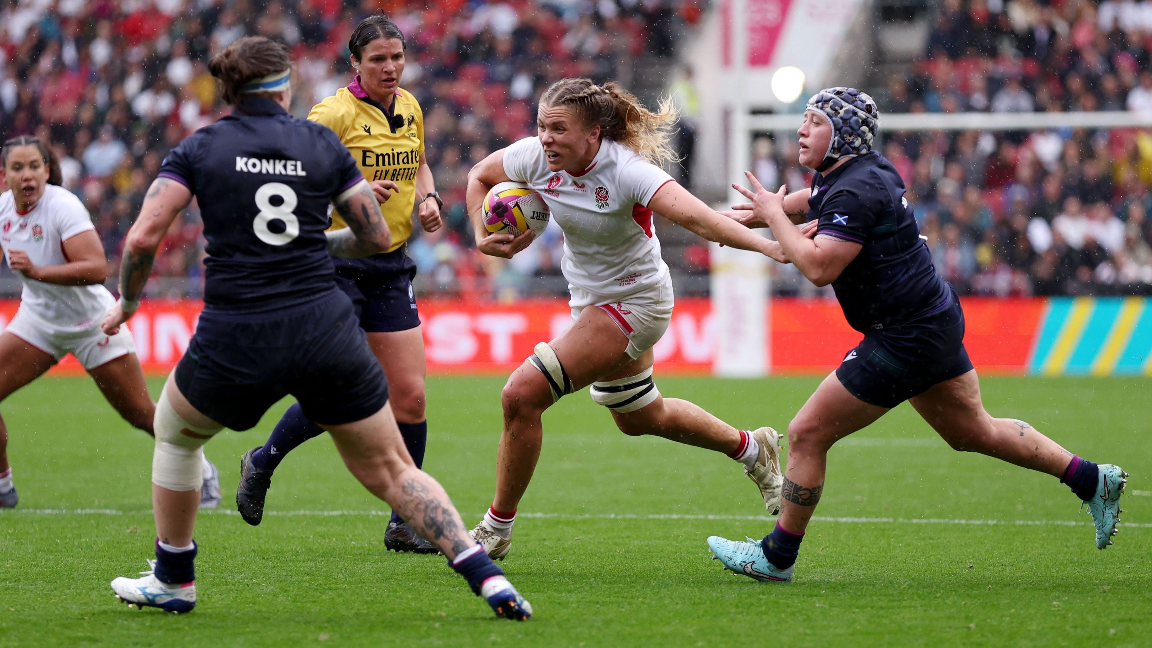 Zoe Aldcroft of England runs with the ball whilst under pressure from Lana Skeldon of Scotland during RWC 2025.