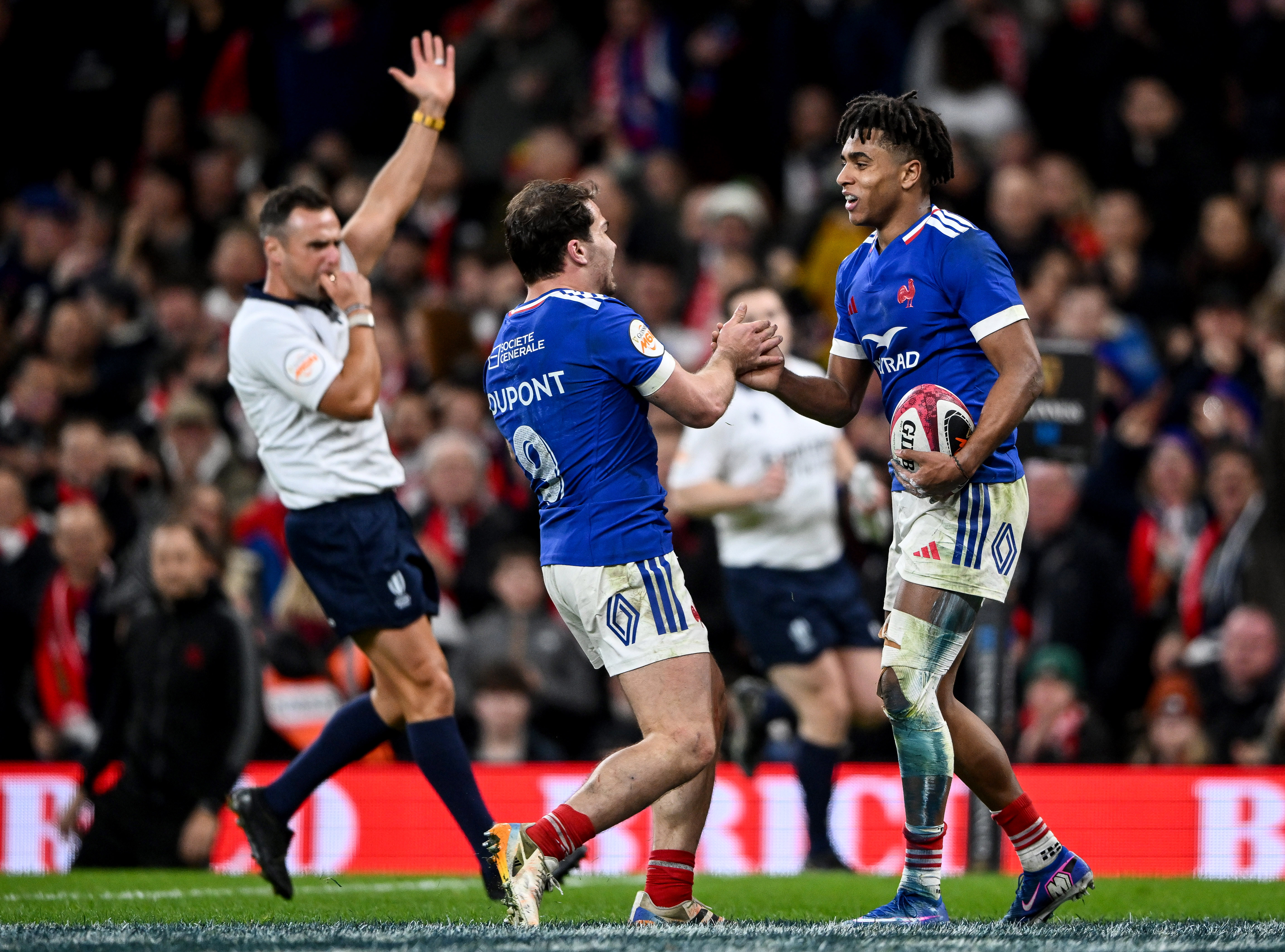France's Theo Attissogbe celebrates with Antoine Dupont after he scores his side's fifth try of the match during the 2026 Guinness Men's Six Nations Round 2 game at Principality Stadium.