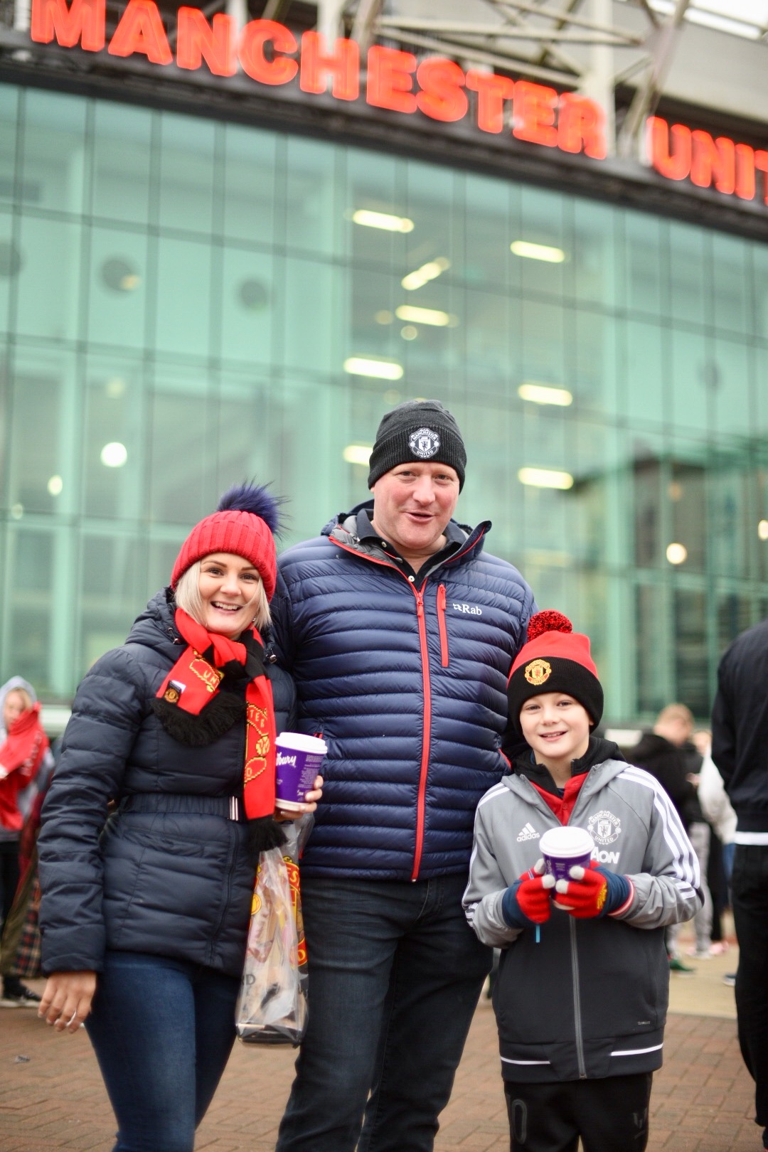 A young fan with family at Old Trafford on matchday